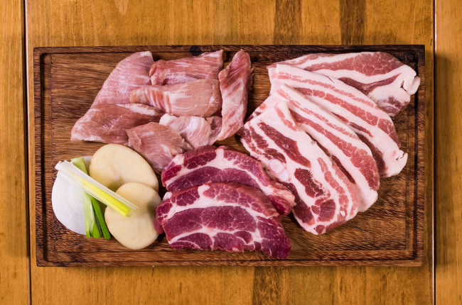 a plate of delicious meat ready to be cooked on a BBQ