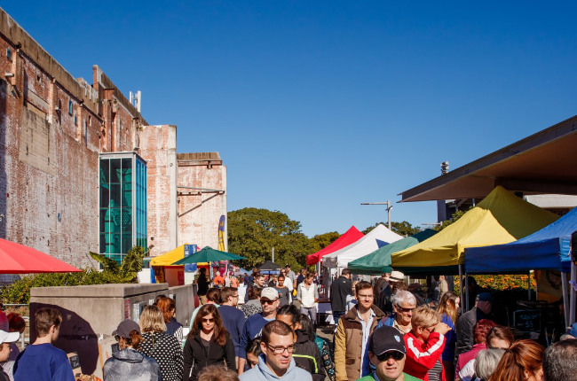 a crowd enjoying jam powers markets on a sunny day