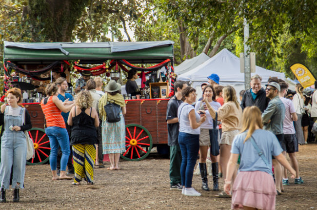 a crowd of people enjoying the markets