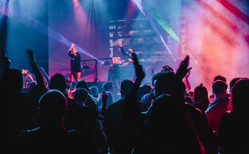 people dancing in a nightclub with strobe lights