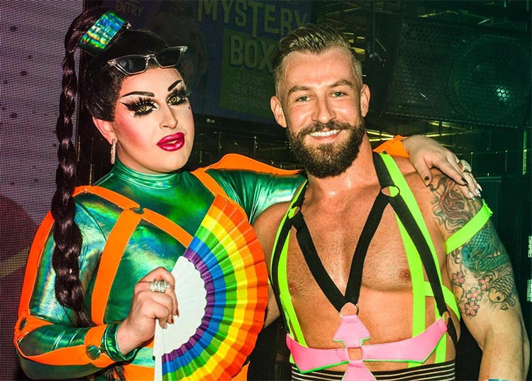 a man and drag queen standing side by side at universal bar in sydney