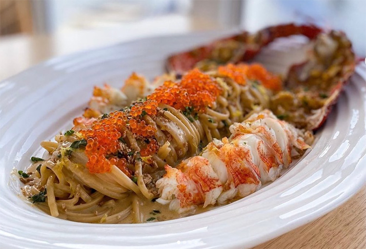 plate of cooked lobster flesh with caviar on top